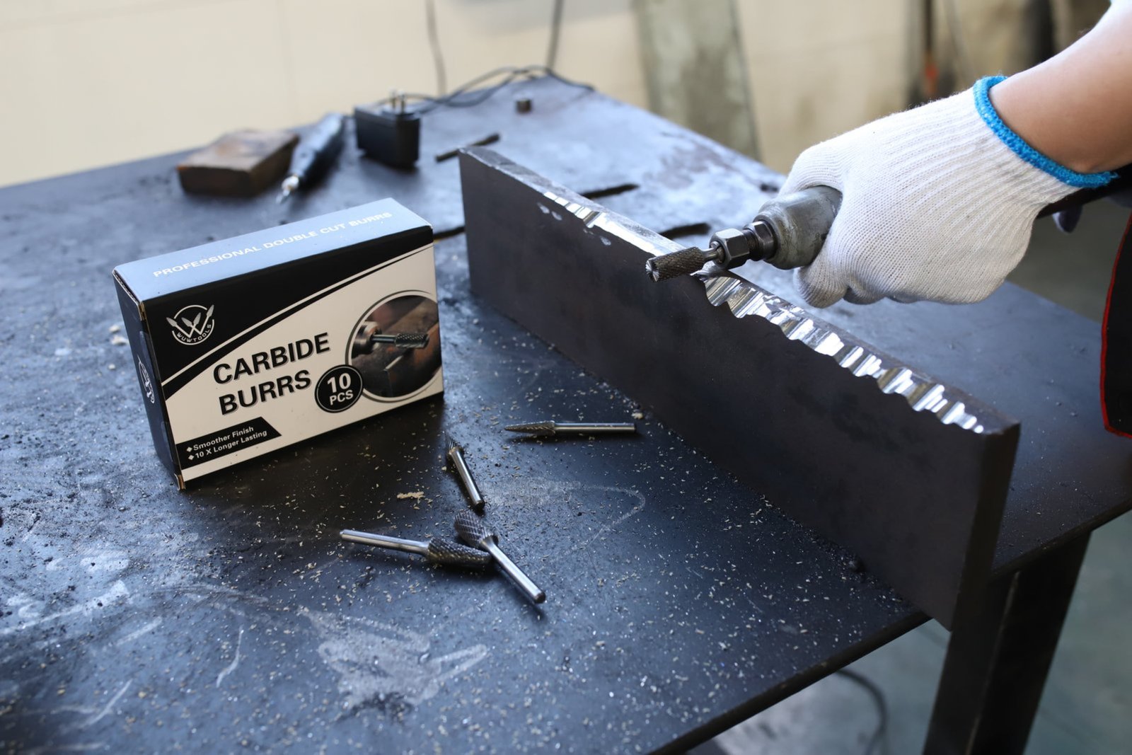 operator wearing safety glasses while using carbide rotary burr on metal workpiece